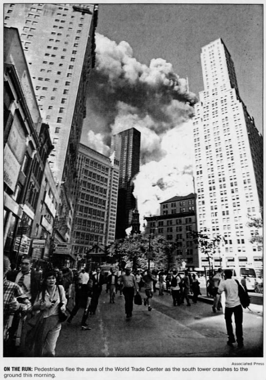 Pedestrians flee the area of the World Trade Center